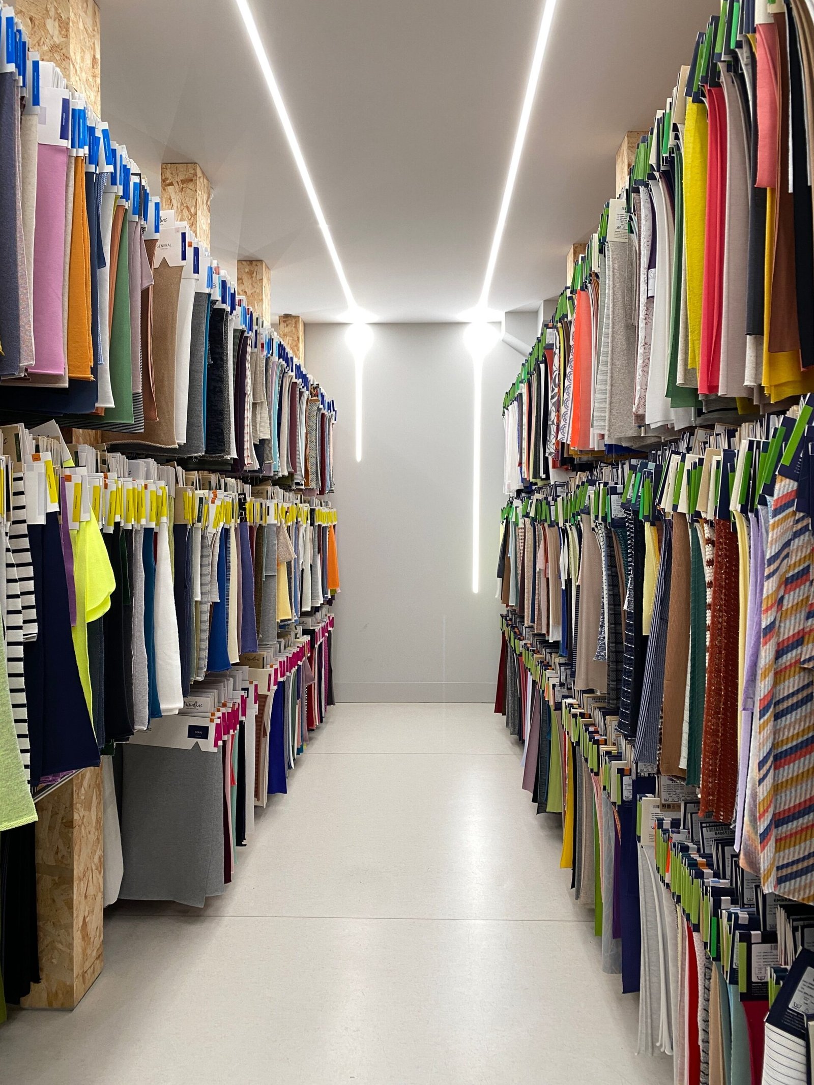 Explore colorful textiles in a retail aisle showcasing diverse patterns and materials. Ideal for fashion inspiration.